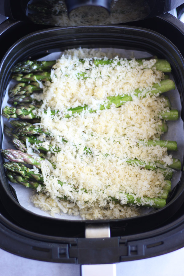 Asparagus topped with breadcrumbs in an air fryer